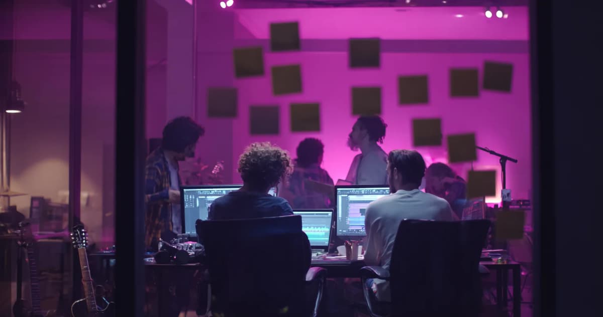 Female music producer working on lyric changes in professional studio
